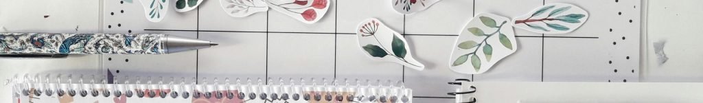 Flat lay of a planner with decorative stickers and stationery for organizing tasks creatively.